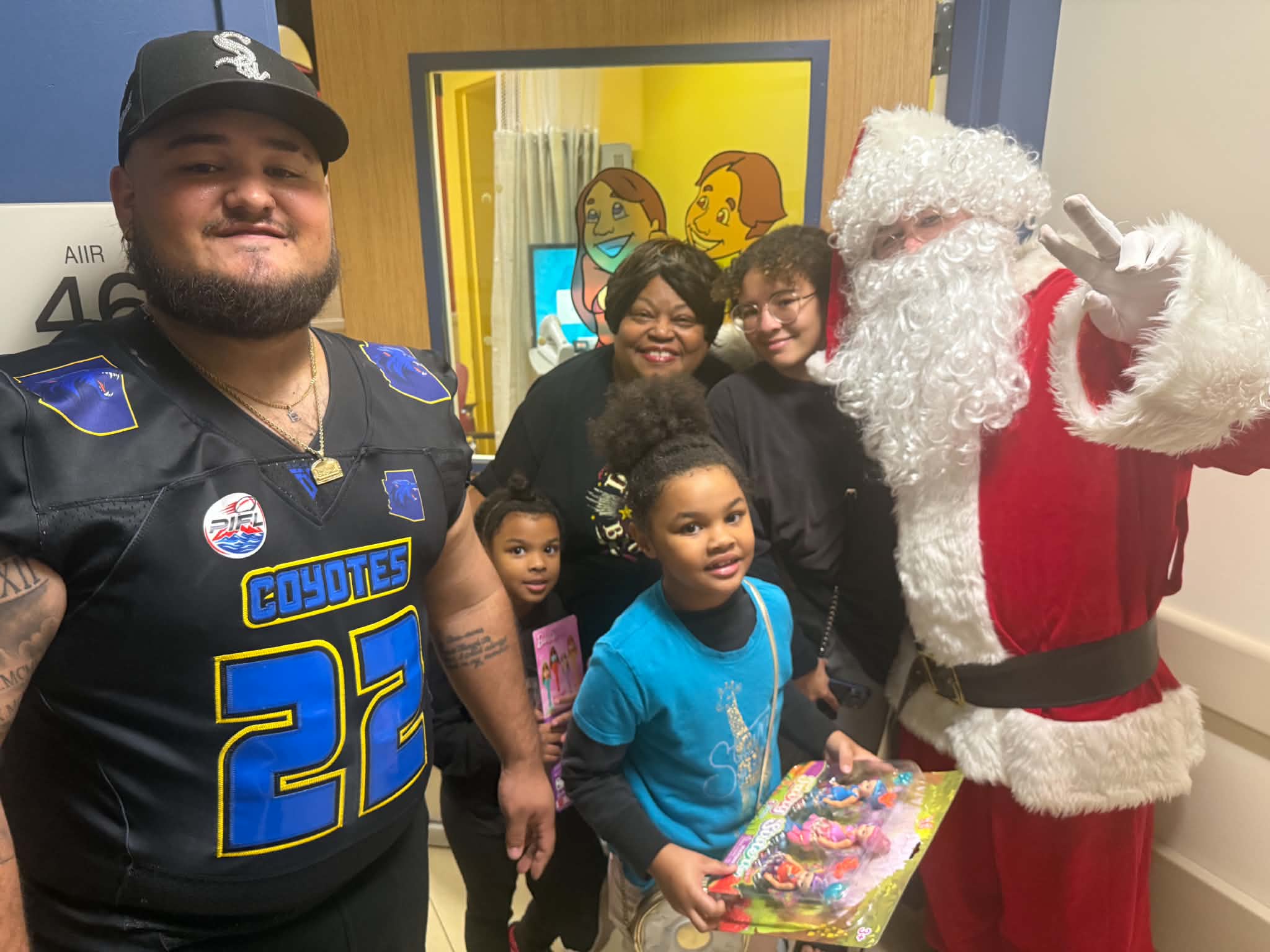 A family and Santa with donated toys